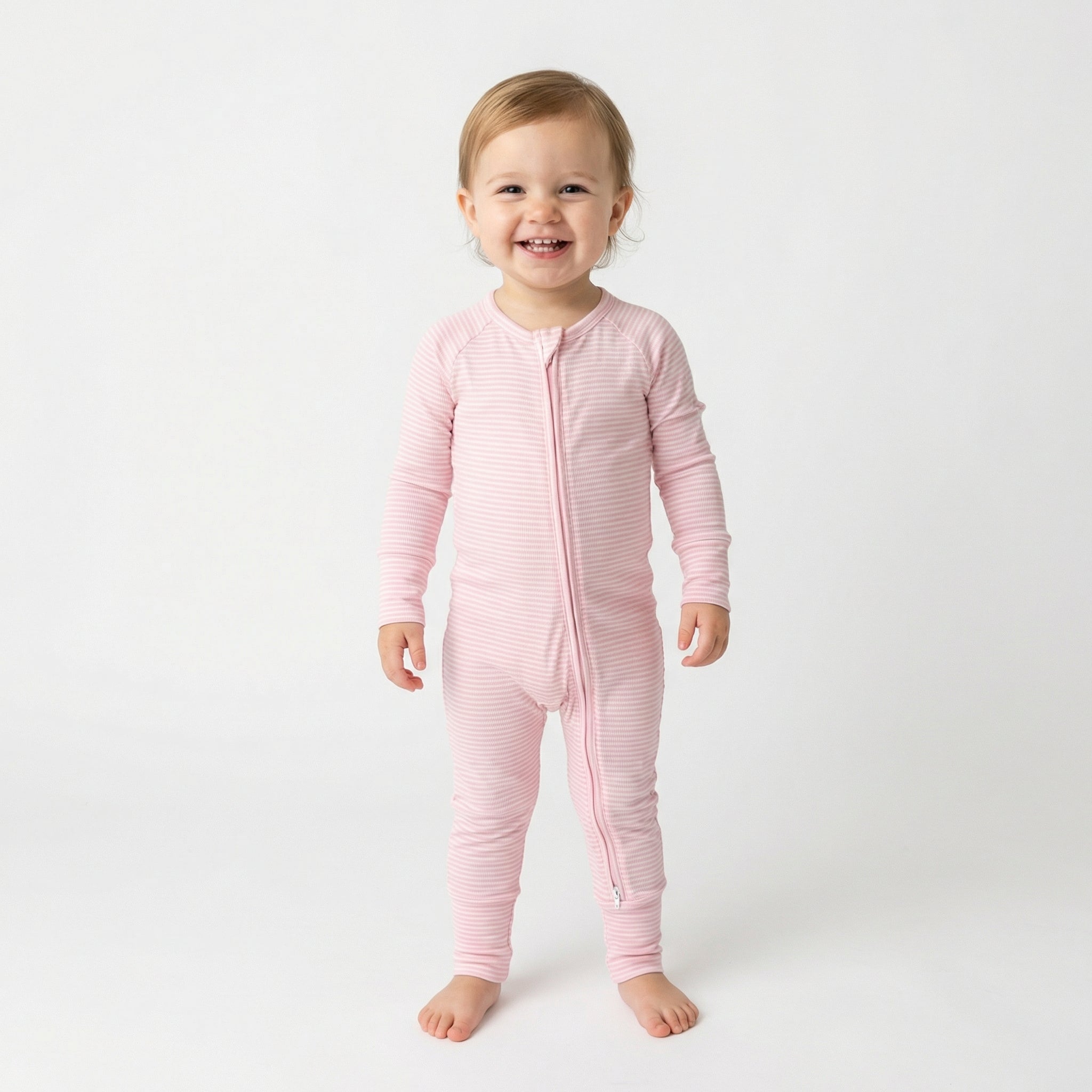 Editor favorite Motette organic bamboo baby sleeper in pink and white stripe designed for everyday comfort