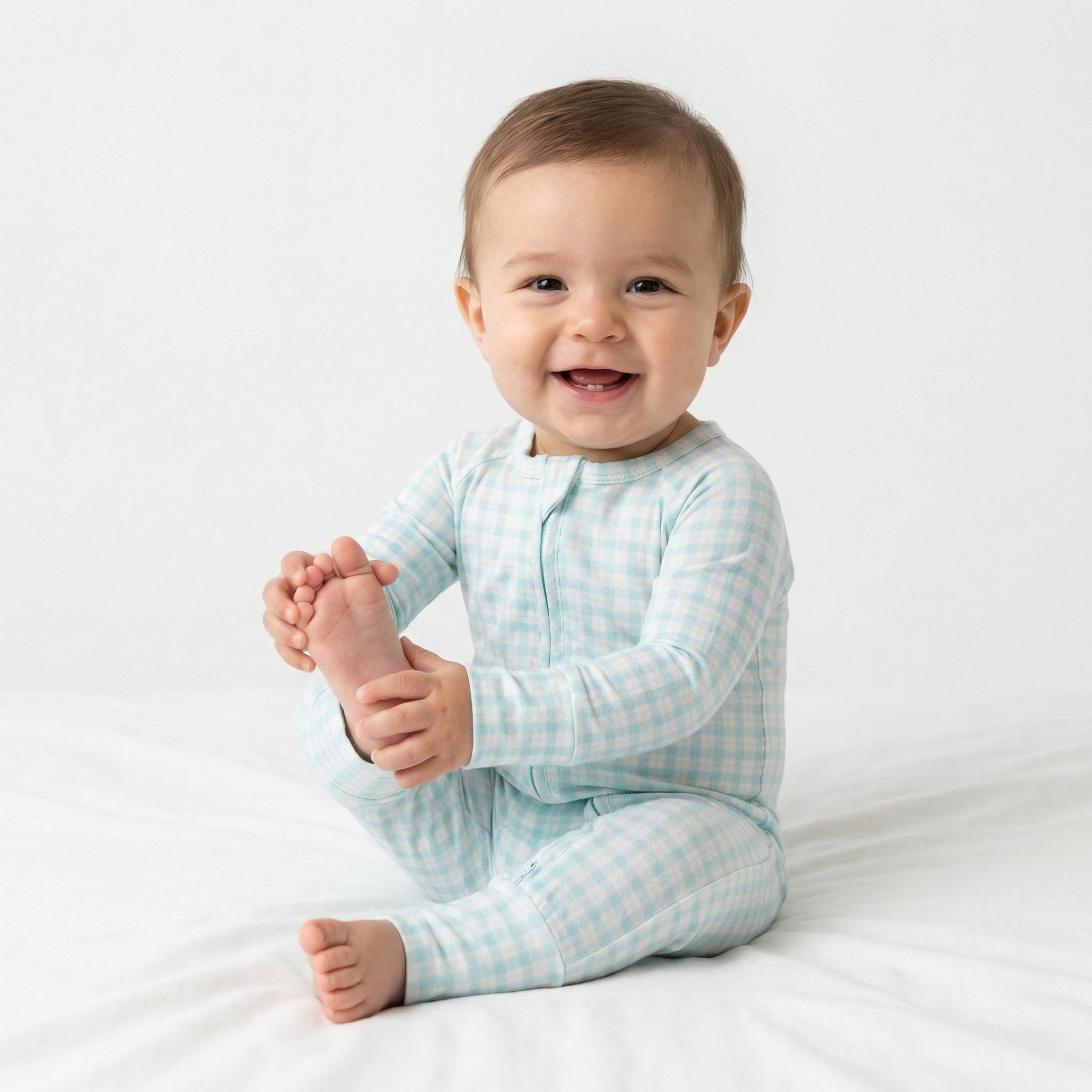Editor favorite Motette organic bamboo baby sleeper in blue and white gingham designed for everyday comfort