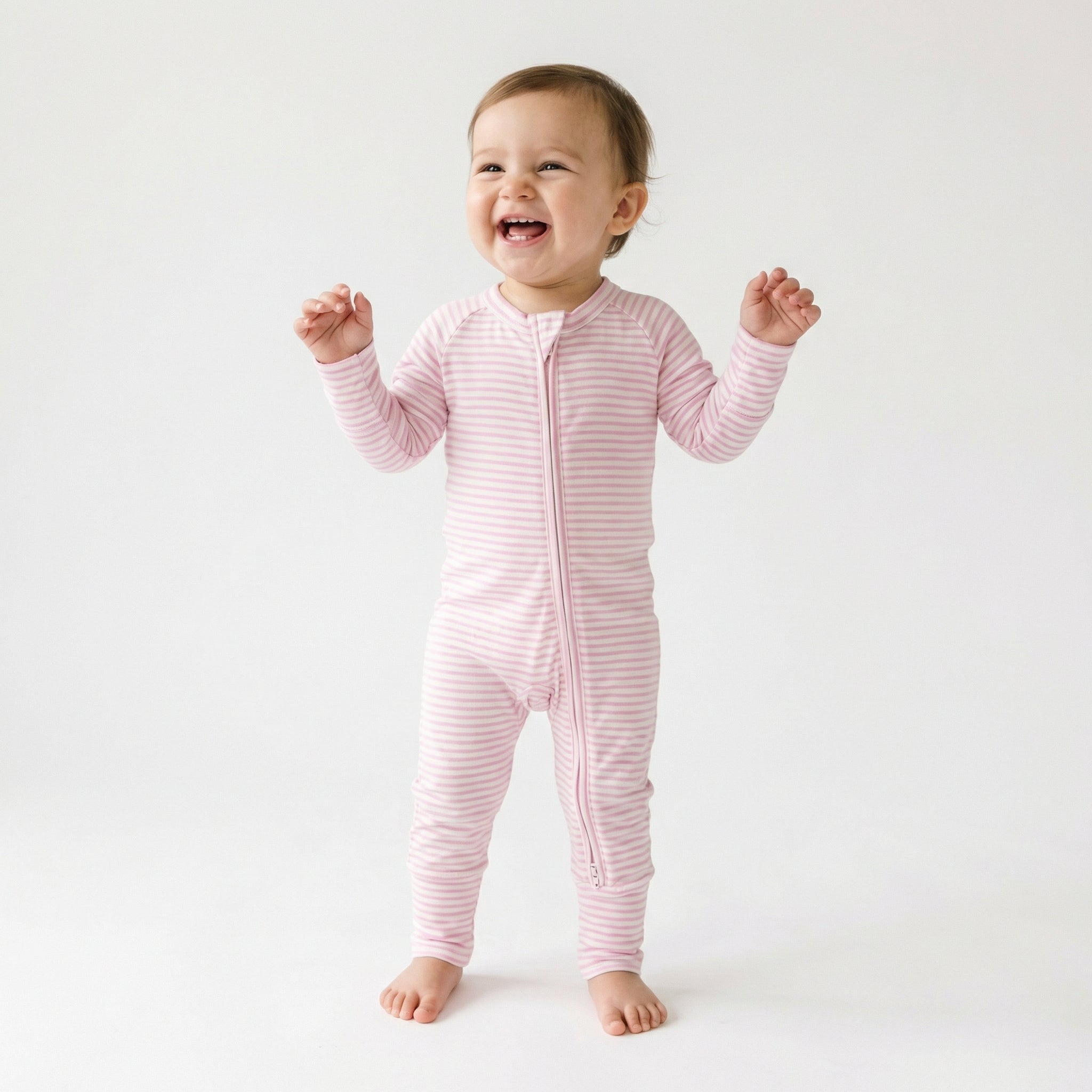 Editor favorite Motette organic bamboo baby sleeper in pink stripe designed for everyday comfort and easy diaper changes
