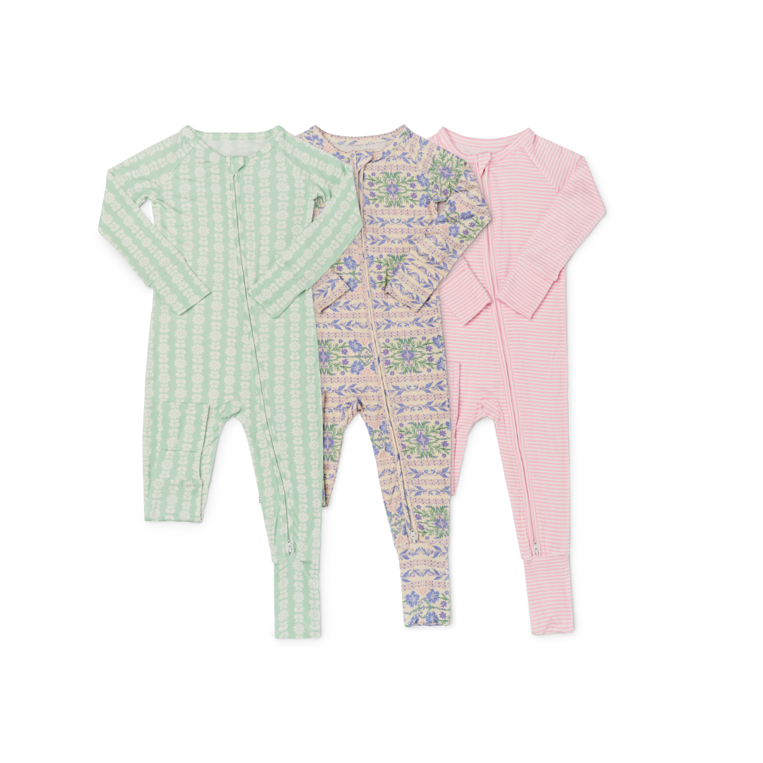 Three Motette bamboo sleepers for baby girls— laid flat side by side