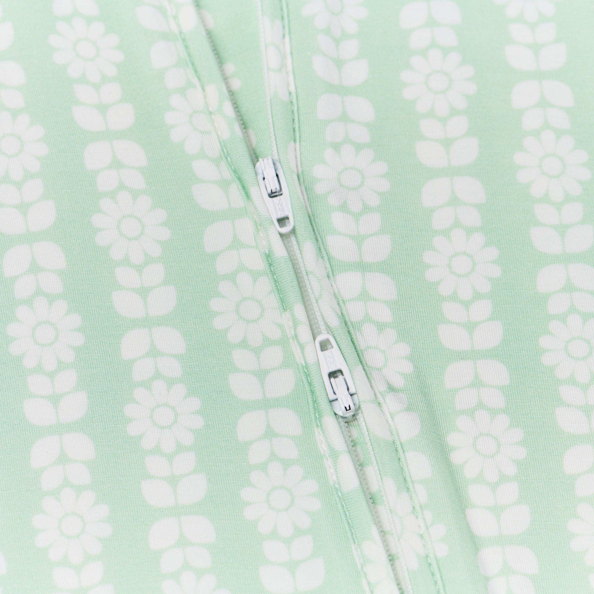 Top rated footed bamboo sleeper in green with white floral trusted by moms for soft, comfortable sleep