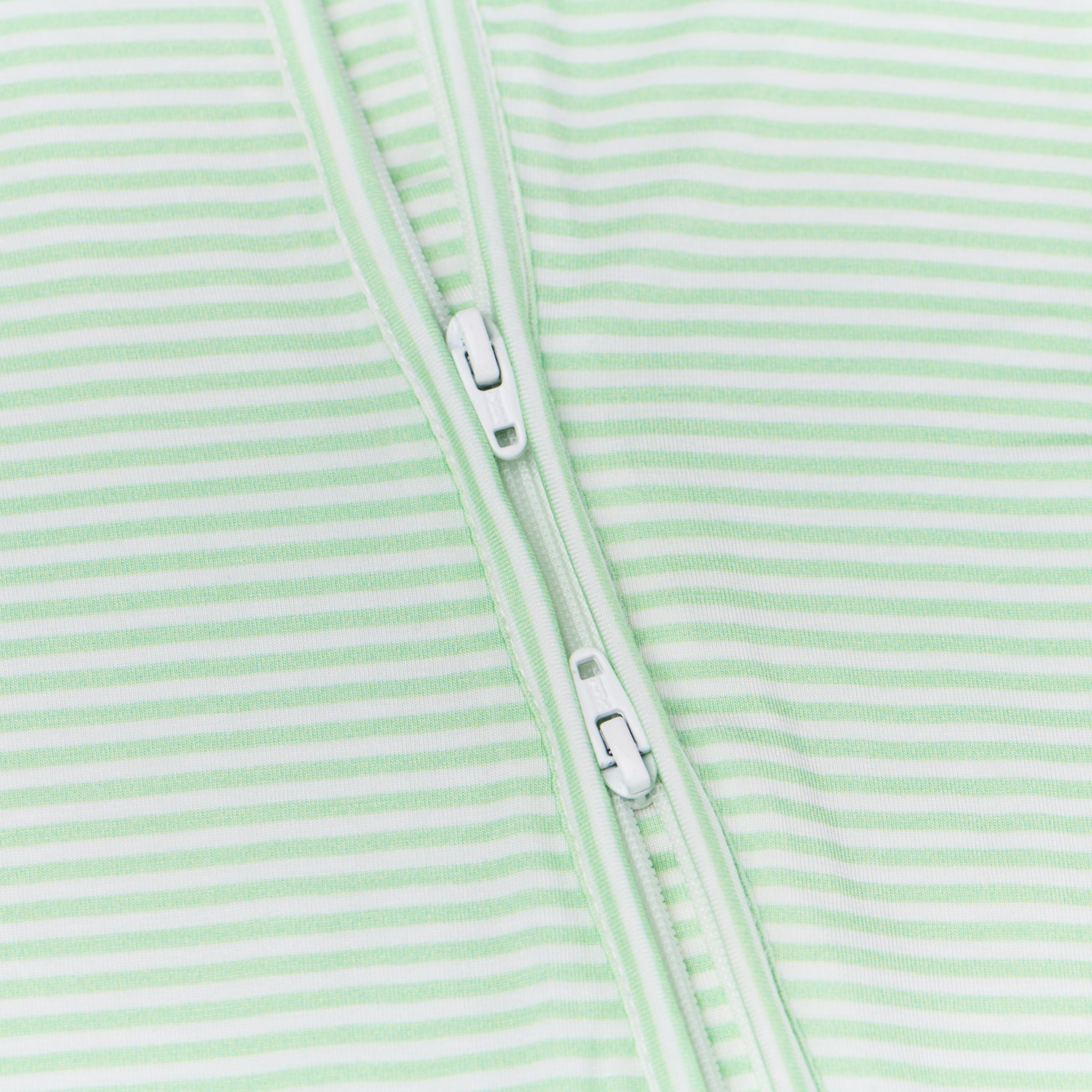 Zoomed-in view of the two-way zipper on the Pear Stripe bamboo sleeper, emphasizing convenience for diaper changes.