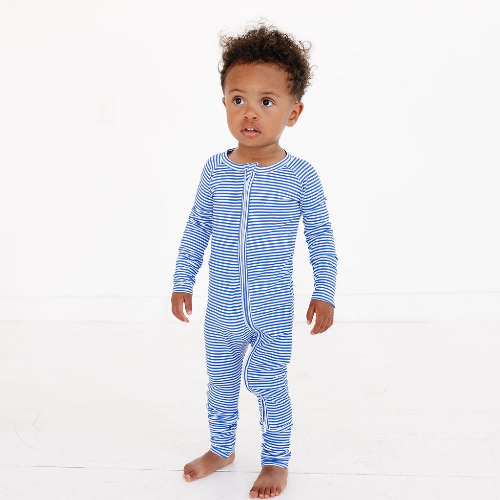 Baby boy standing in full-length view wearing Cobalt Stripe zipper bamboo sleeper by Motette – soft, eczema friendly pajamas for sensitive skin