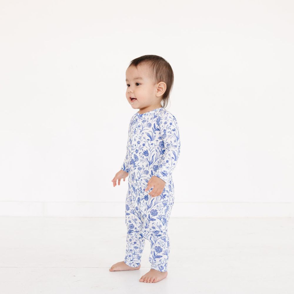 Baby standing in profile wearing Porcelain Vine bamboo sleeper by Motette – top-ranked pajamas for eczema prone skin
