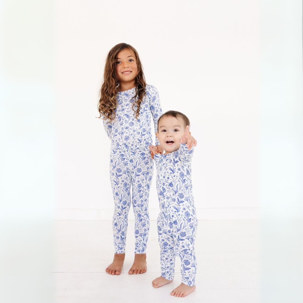 Baby and sibling in coordinated bamboo pajamas in Porcelain Vine by Motette – soft, breathable sibling sleepwear set