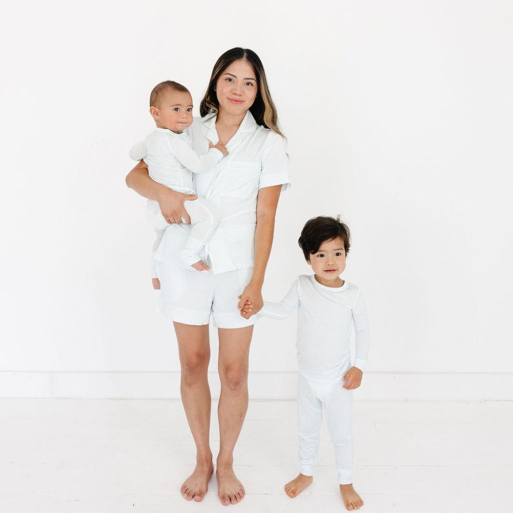Mom standing with baby and toddler wearing matching Cloud Stripe pajamas – coordinated sibling sets by Motette, top-ranked bamboo pajamas, eczema friendly