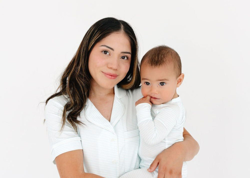 Mom holding baby in coordinating Cloud Stripe bamboo pajamas – mommy and me matching styles by Motette, eczema friendly