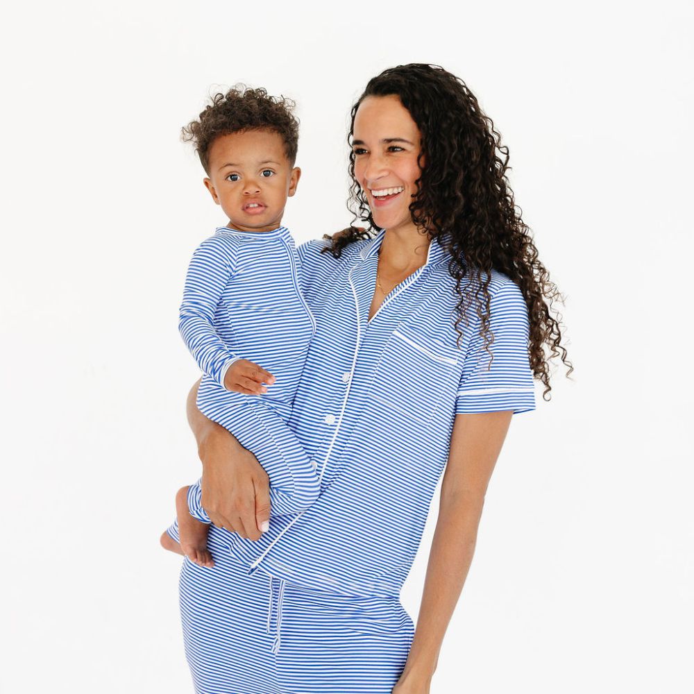 Mommy holding baby boy in matching bamboo pajamas in Cobalt Stripe by Motette – coordinated family sleepwear for sensitive skin