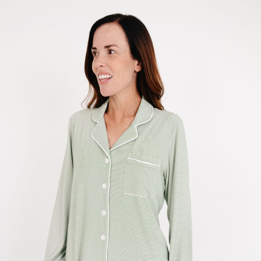 Mommy wearing the Motette Evergreen Stripe Bamboo Women's Pajama Top, featuring a soft green and white striped pattern, button-up front, chest pocket, and white piping detail.