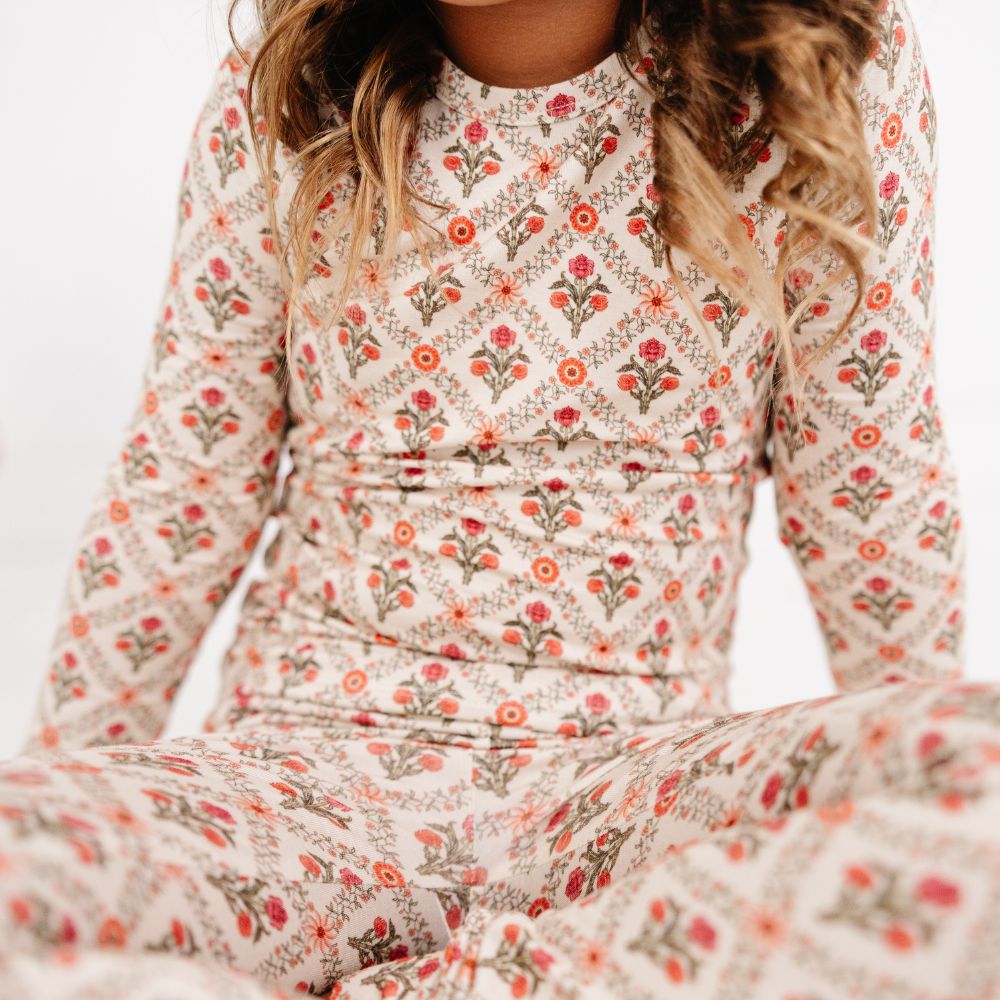 Close-up of a child wearing Motette Holly Trellis Bamboo Kids Pajama Set, showing floral pattern details.
