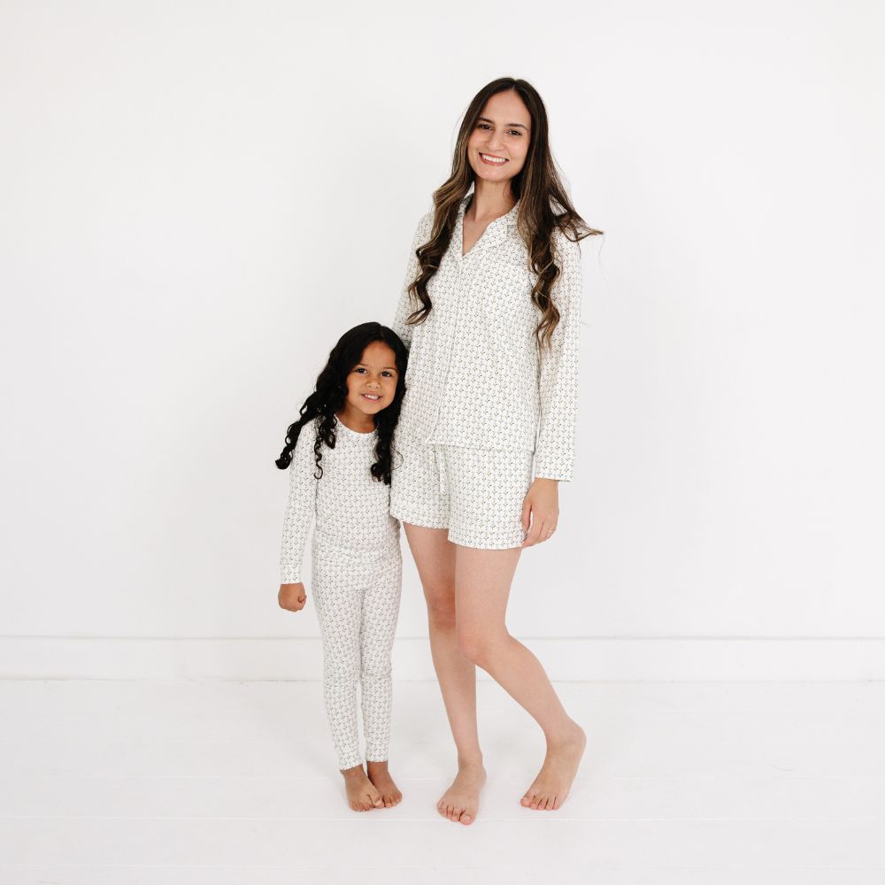 Mommy and daughter standing and hugging while wearing matching Motette Lavender Lane Bamboo Pajama Sets.
