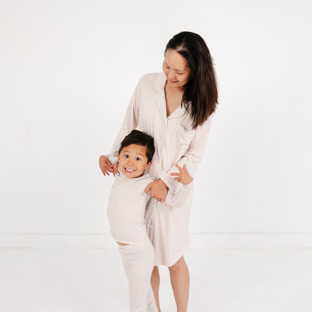Mommy in matching Oatmeal Stripe Bamboo Nightshirt hugging her playful son in Motette Oatmeal Stripe Kids Pajama Set.