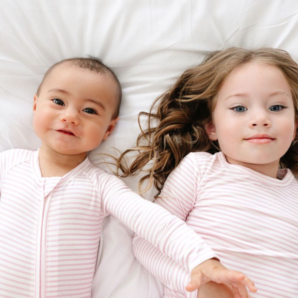 Siblings in matching Ballet Stripe Bamboo Sleepers – coordinated sibling set by Motette, perfect for eczema sensitive skin