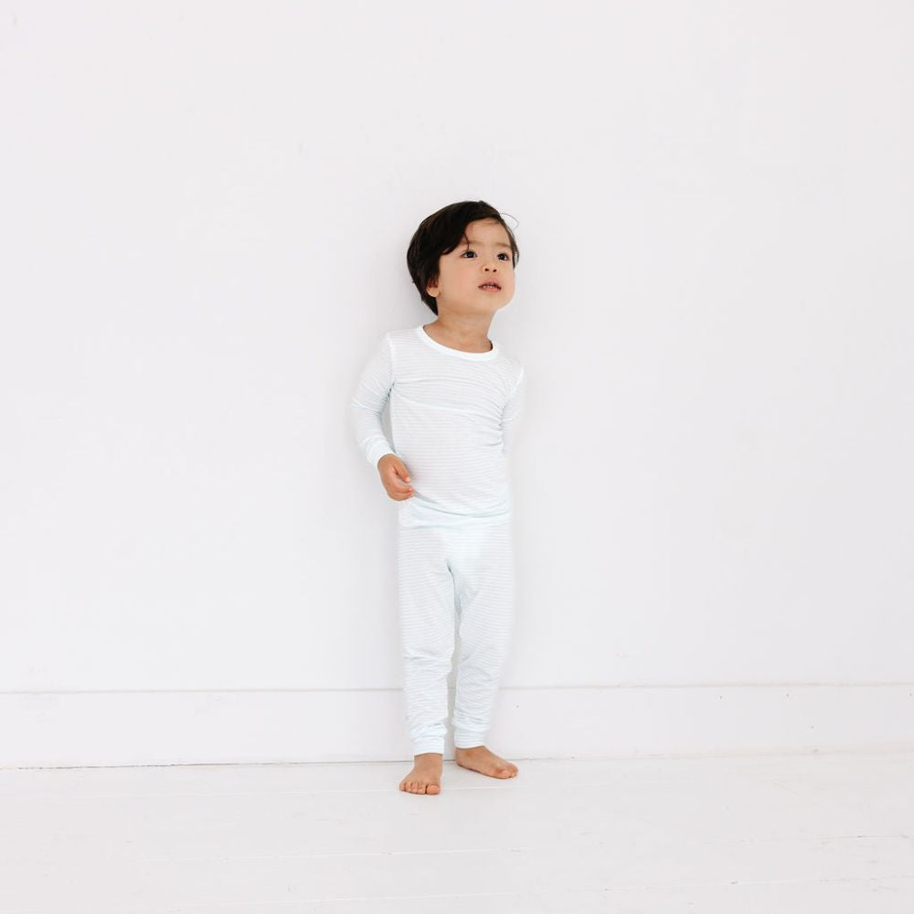 Toddler standing in full view wearing Cloud Stripe bamboo pajamas by Motette – top-ranked bamboo pajamas for sensitive skin