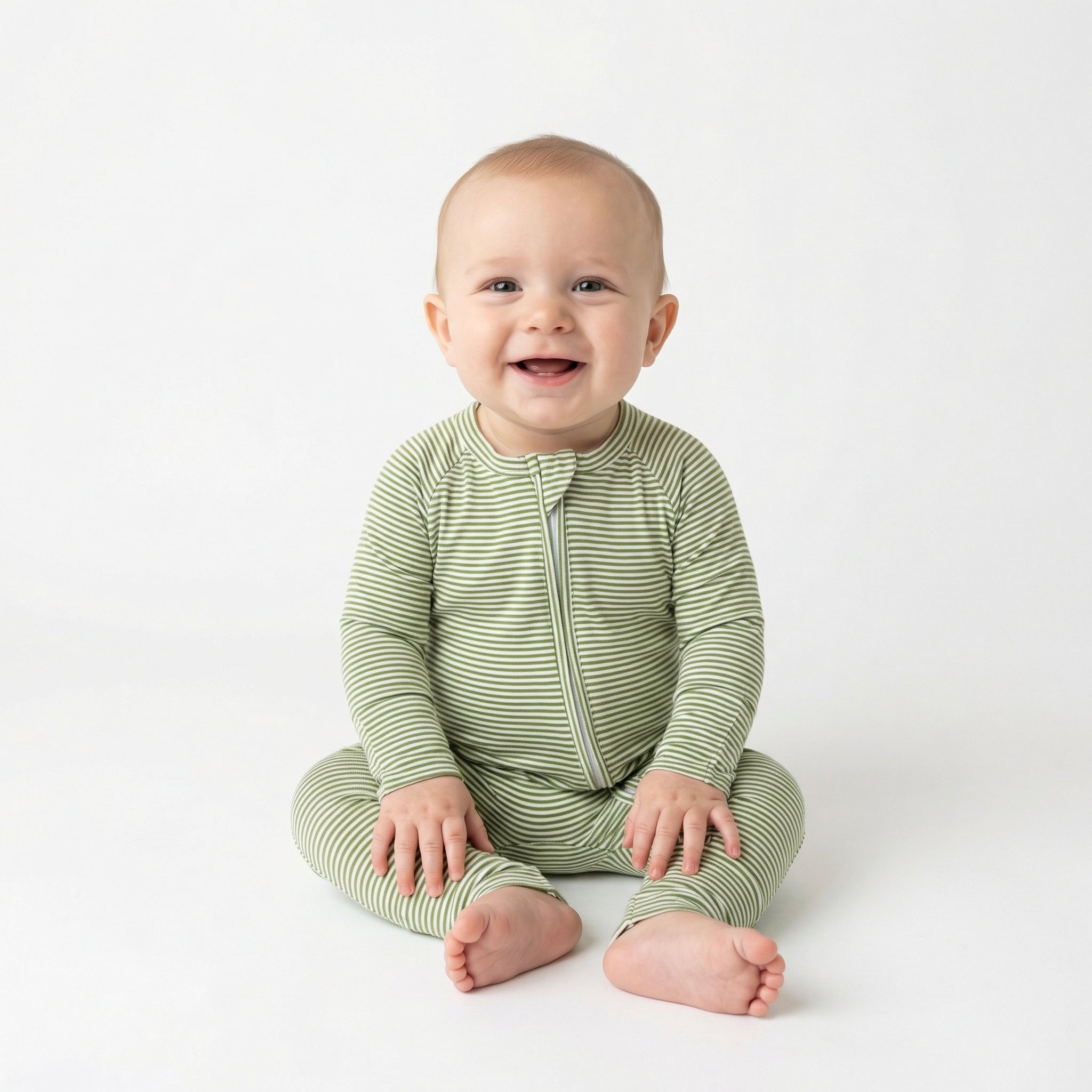 Editor favorite Motette organic bamboo baby sleeper in green and white stripe designed for everyday comfort