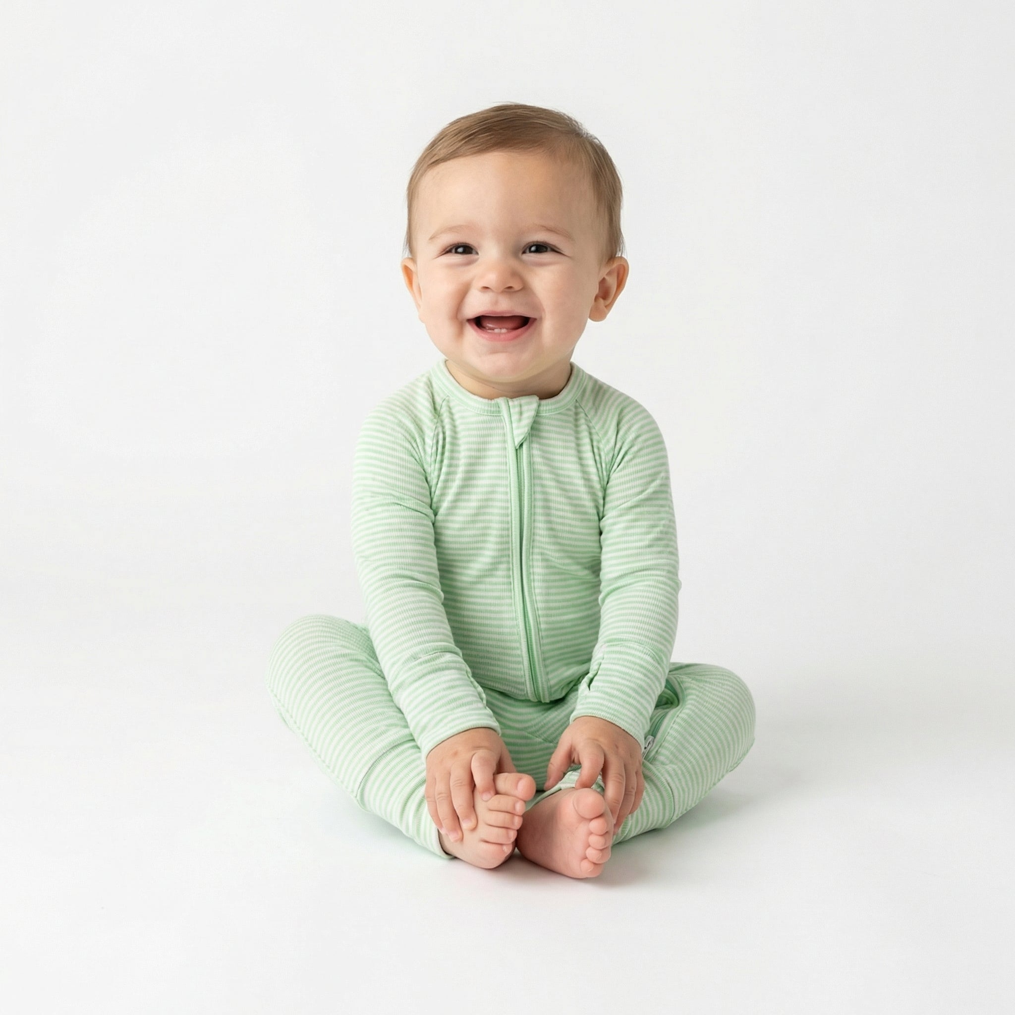 Top rated footed bamboo sleeper in green and white stripe trusted by moms for soft, comfortable sleep