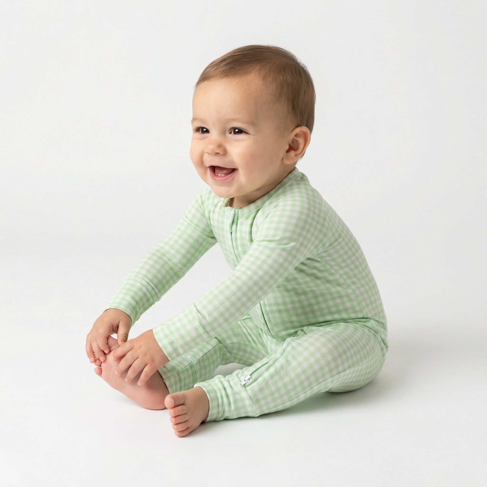 Top ranked breathable bamboo baby sleeper in green gingham loved by parents of newborns with sensitive skin
