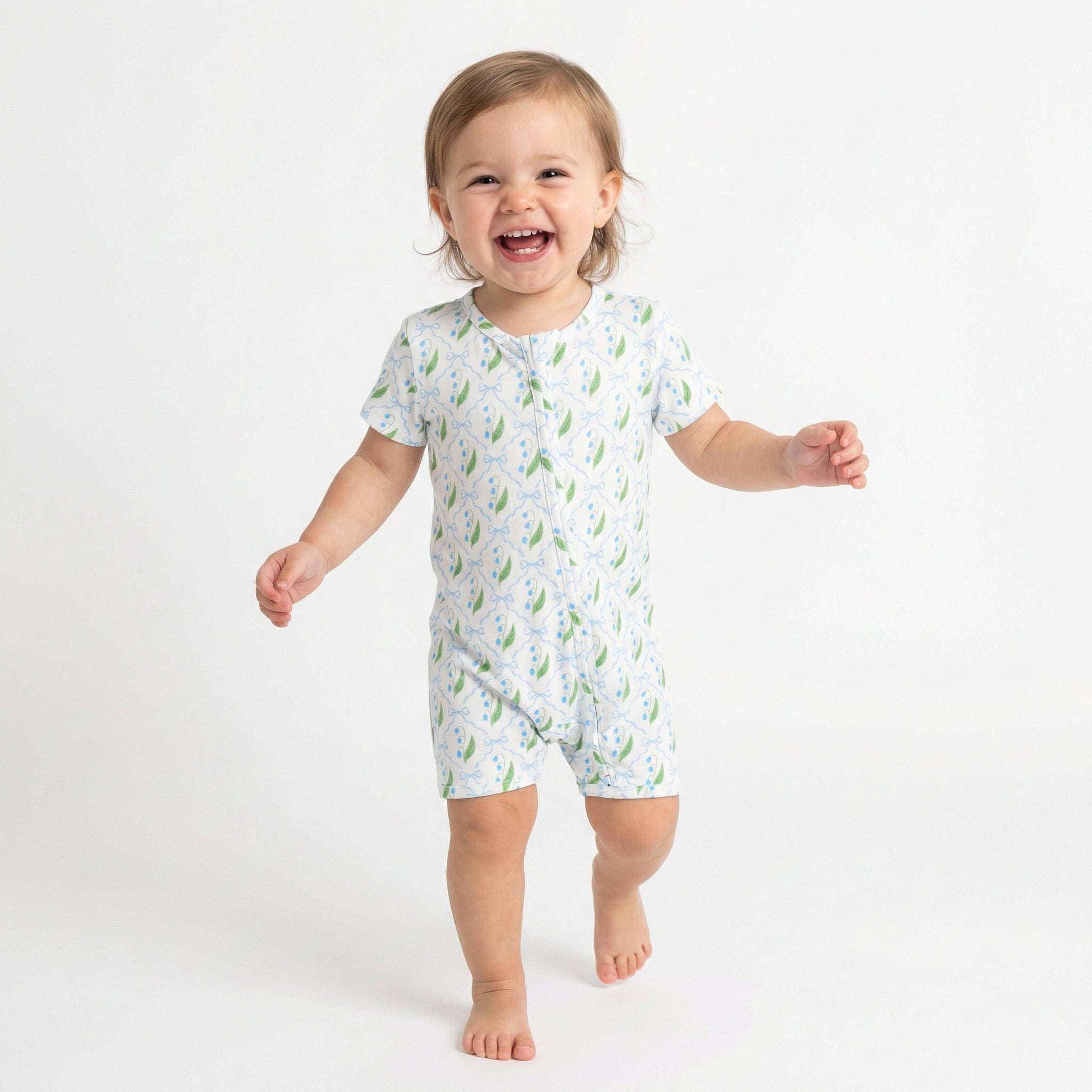 Editor favorite Motette organic bamboo baby sleeper in white with green leaves designed for everyday comfort
