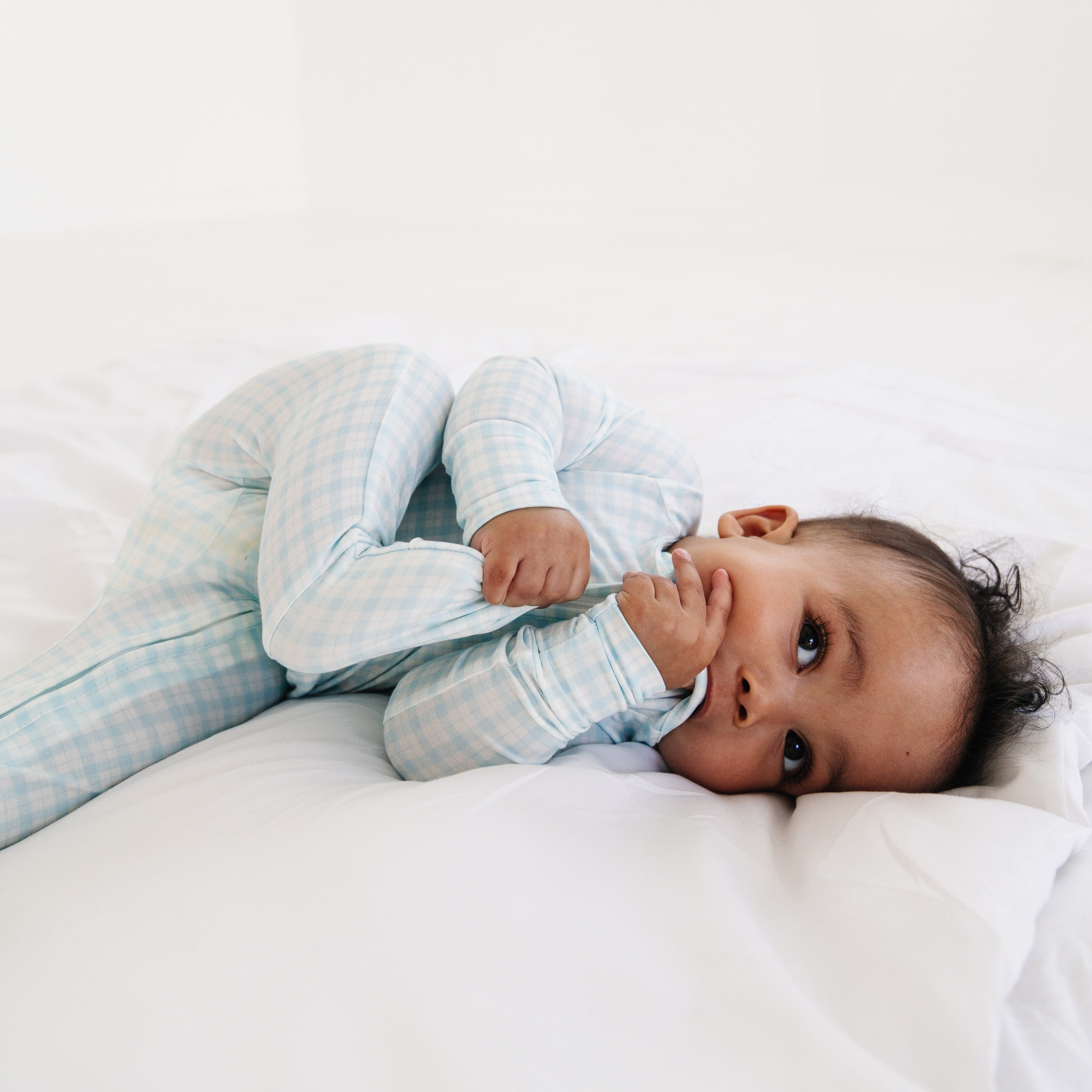 Baby tugging bamboo fabric in blue checkered sleeper or zipper romper