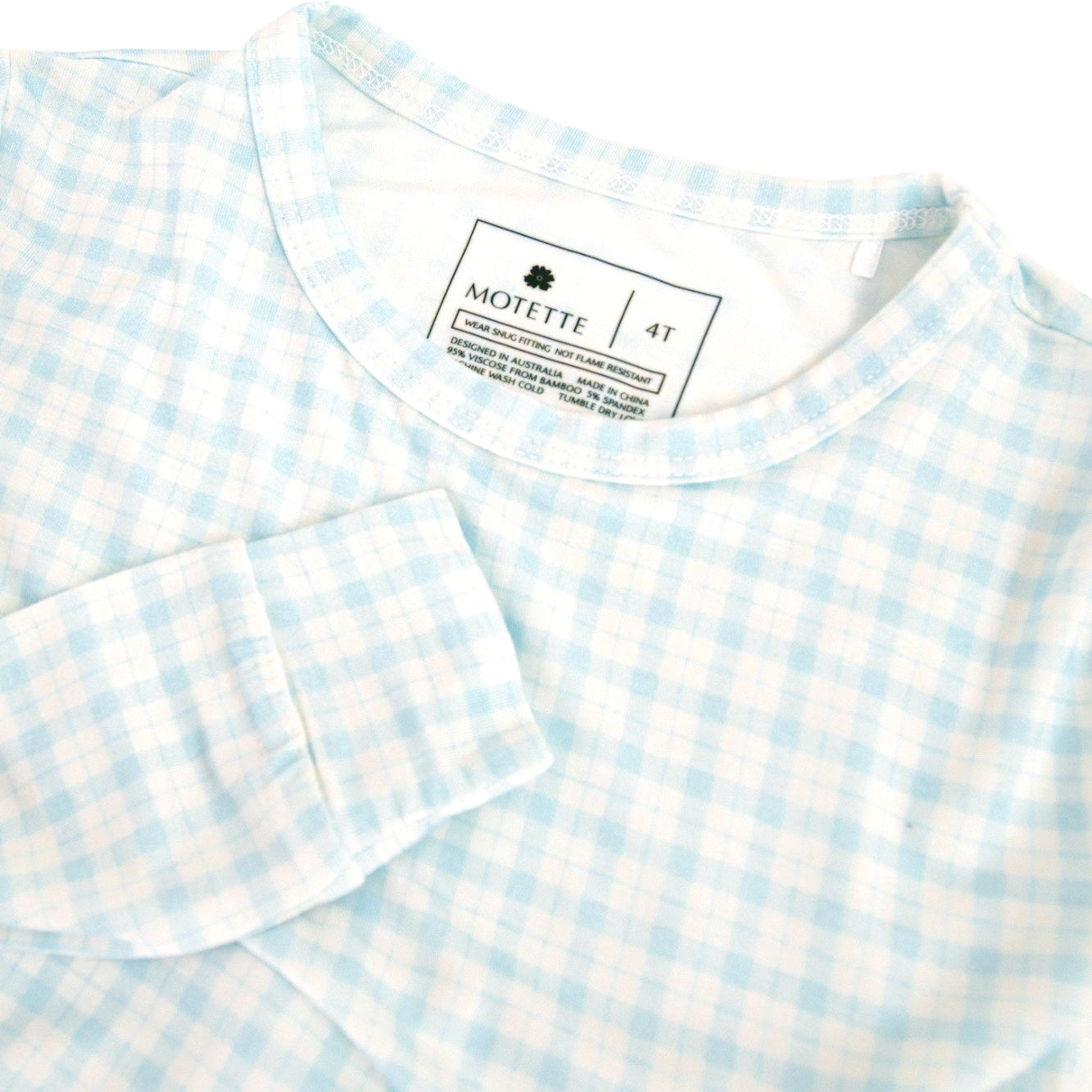 Close-up of blue checkered pajama top and pants, highlighting soft bamboo fabric and classic print.