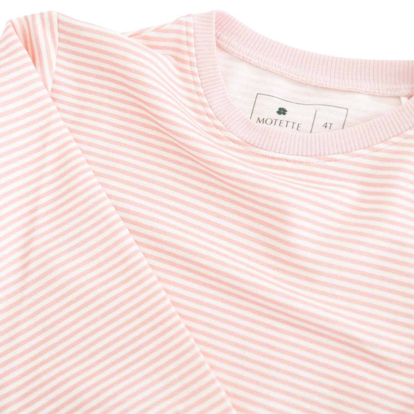 Flat lay of Motette’s pink striped bamboo lounger sweatsuit, highlighting the soft texture and tag free label 
