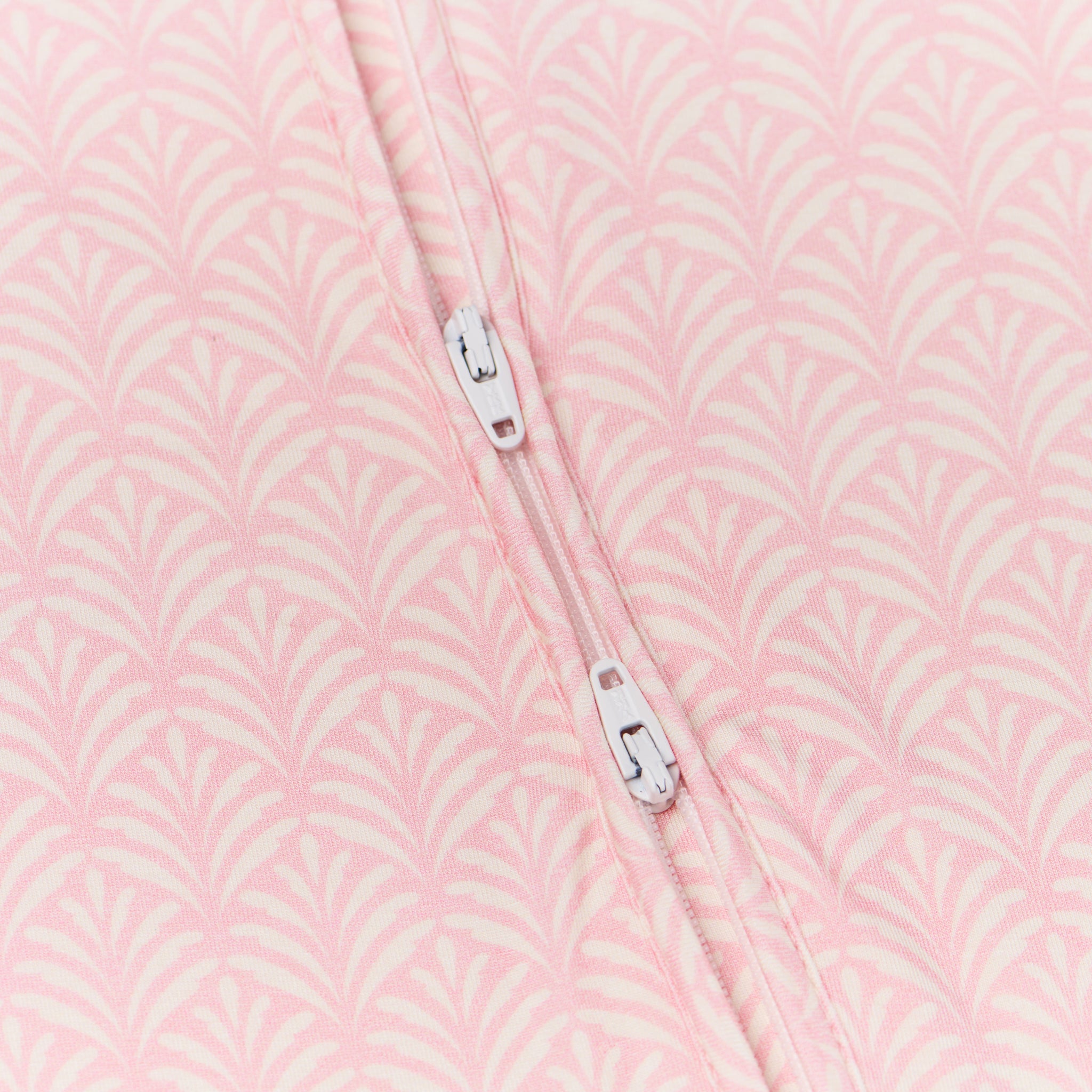 Close-up of the two-way zipper on the sleeper, designed for easy, mess-free changes