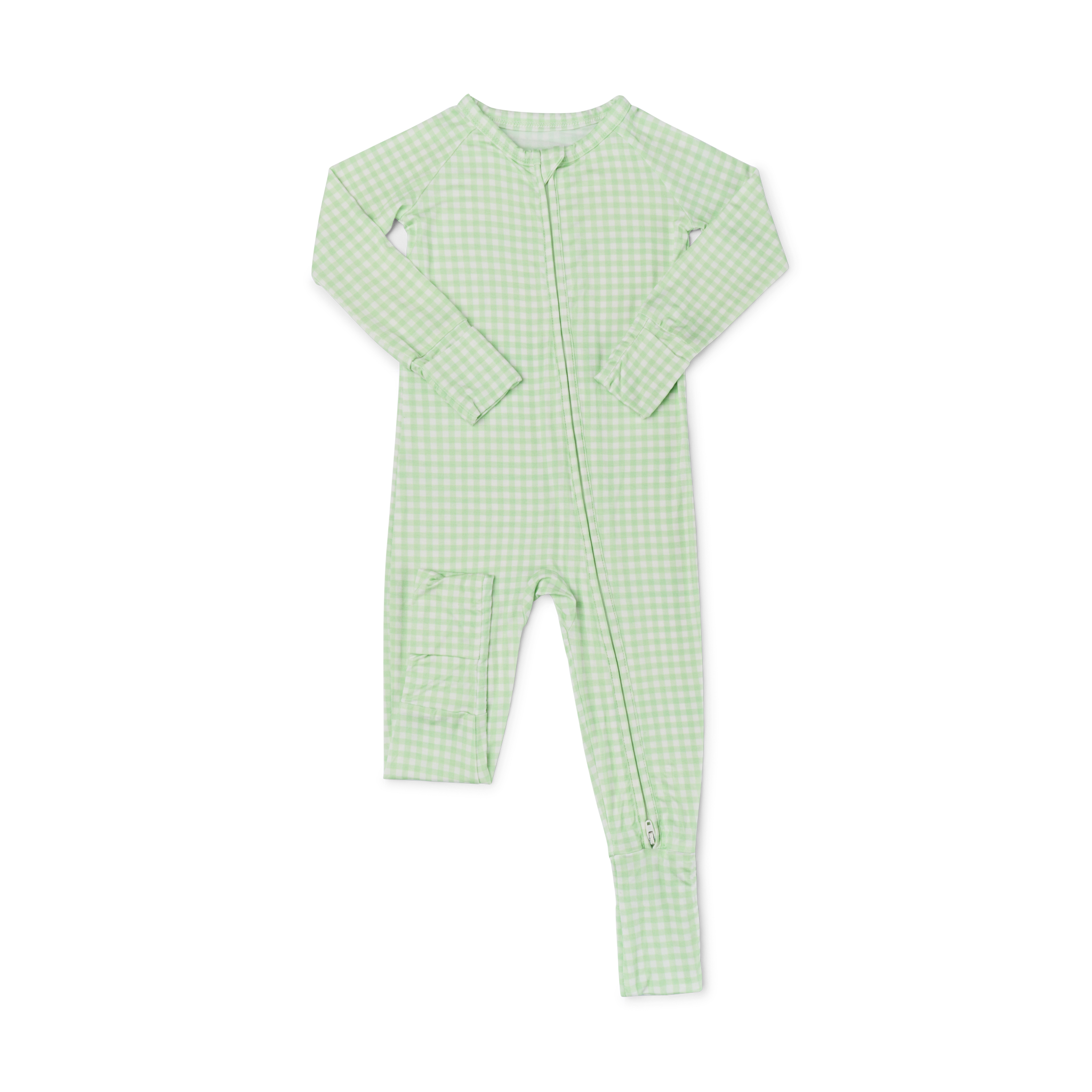 Detail shot of the fold-over cuffs, with baby laying down, featuring the green checkered print and convertible foot detail