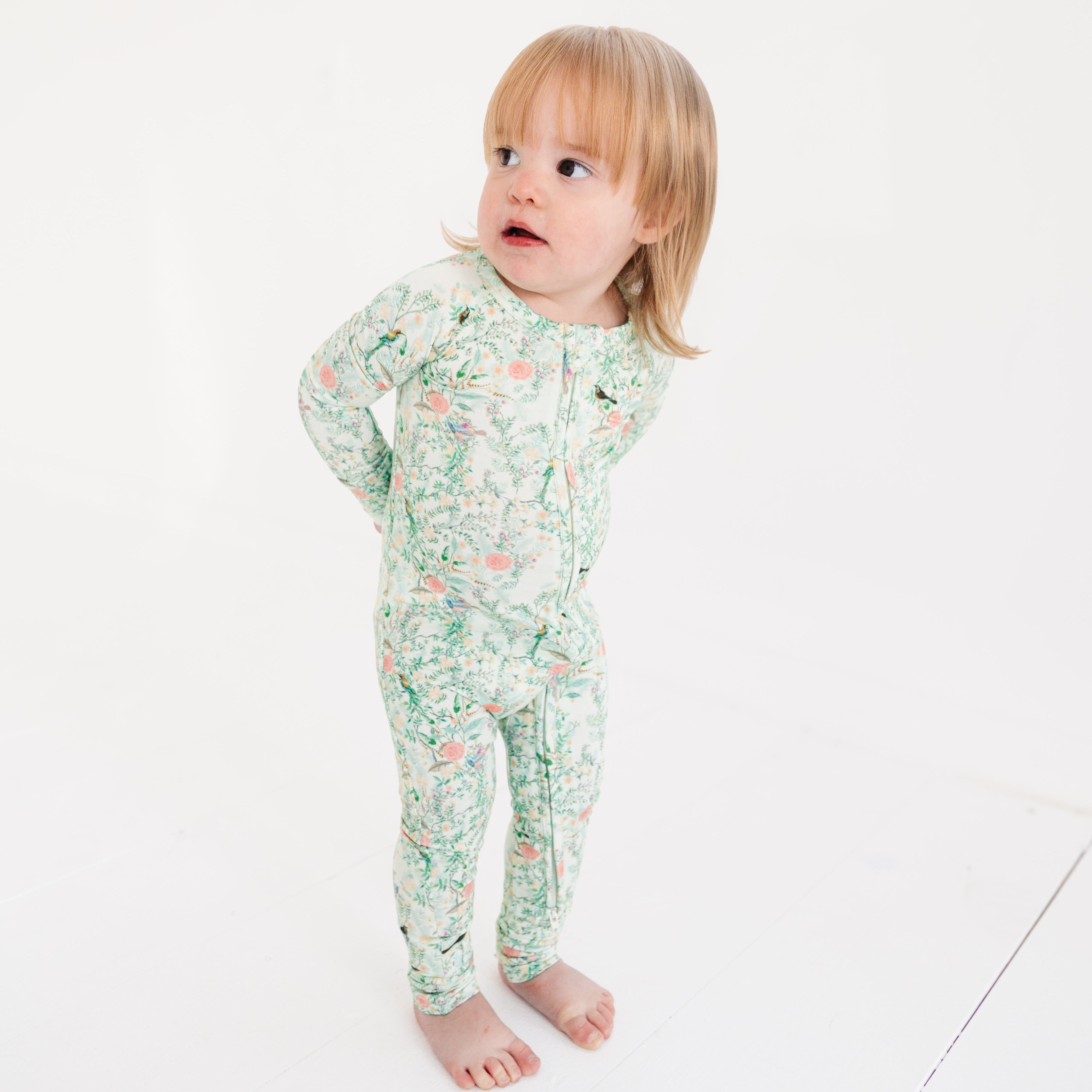 Baby girl wearing green floral bamboo sleeper
