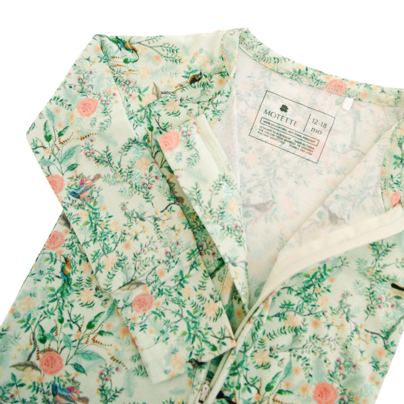 Detail shot of green floral bamboo sleeper, highlighting soft fabric, fold-over cuffs, and floral print.