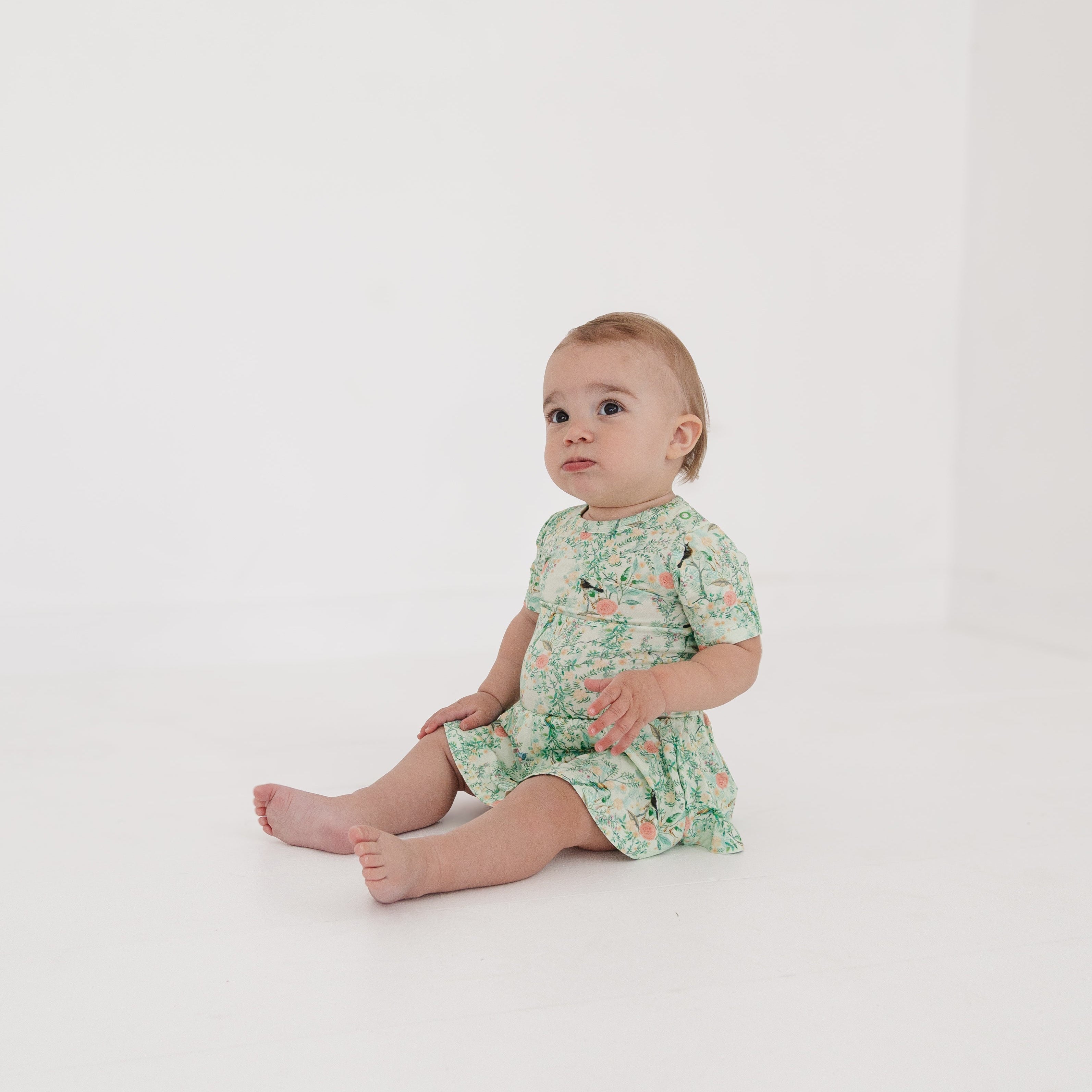 Bamboo twirl dress with bodysuit and snaps shown on baby girl
