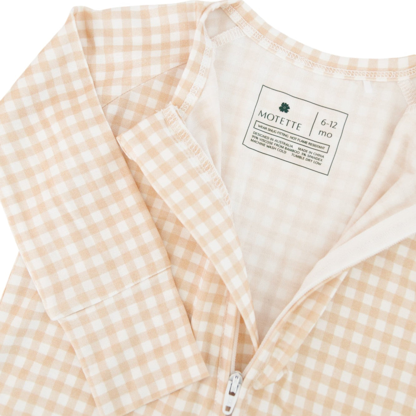 Close-up of beige checkered bamboo sleeper, showing two way zipper and tagfree heat label 