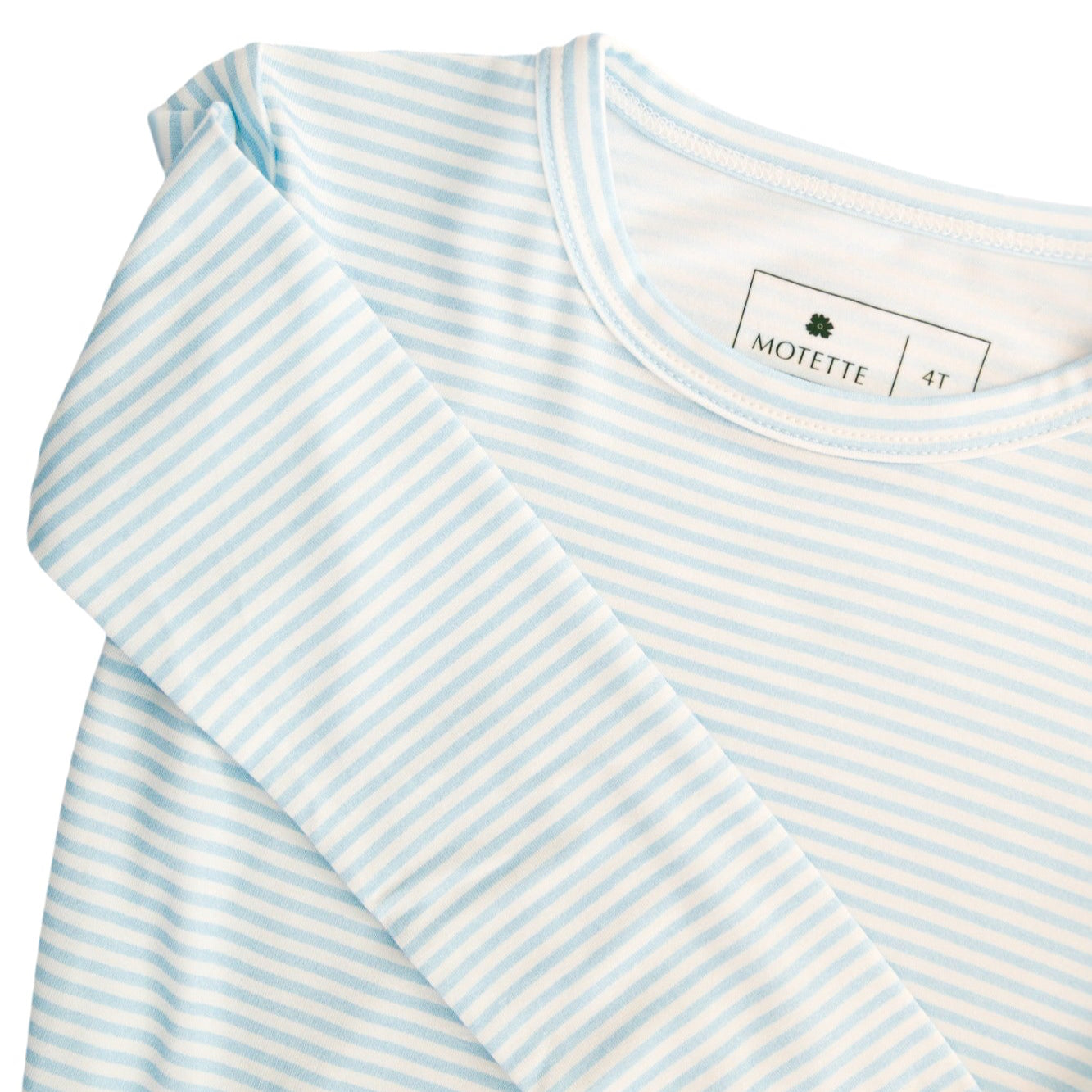 Detailed close-up of the Seaside Stripe fabric and printed tag inside the pajama top, showing the bamboo material and tag-free design.