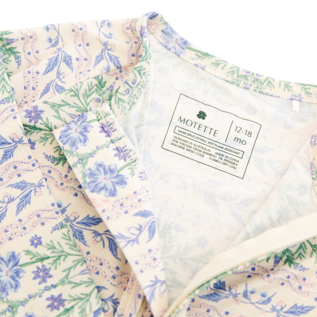 Detail shot of the tag-free label inside the sleeper, emphasizing comfort for sensitive baby skin
