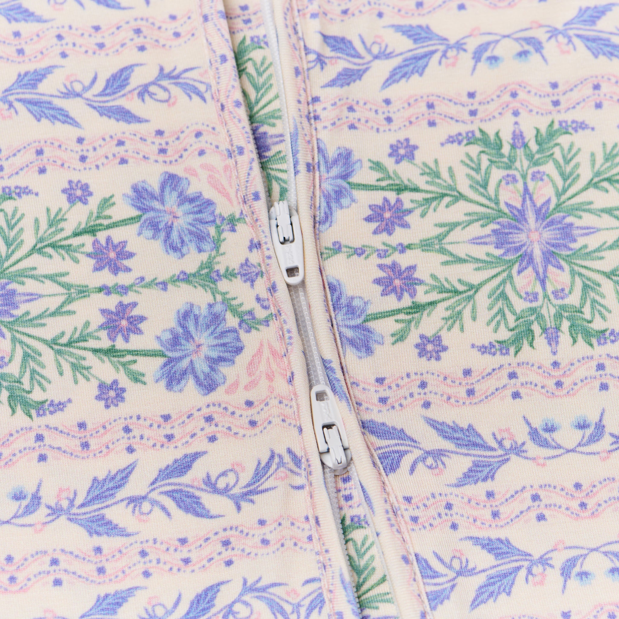 Close-up of the sleeper’s two-way zipper, showing easy-access functionality for diaper changes