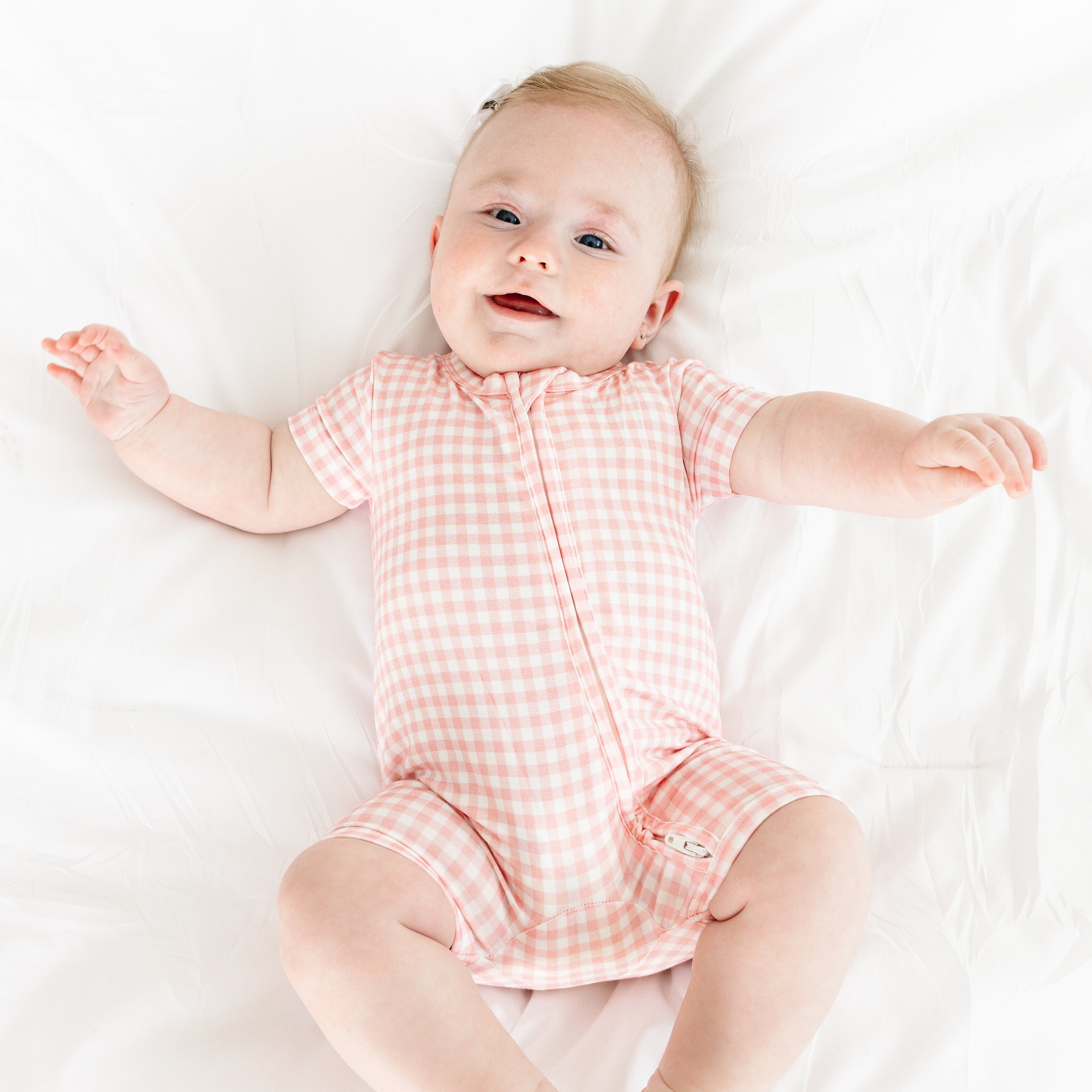 Baby smiling while wearing the Sugar Gingham Short Sleeve & Shorts Bamboo Sleeper by Motette