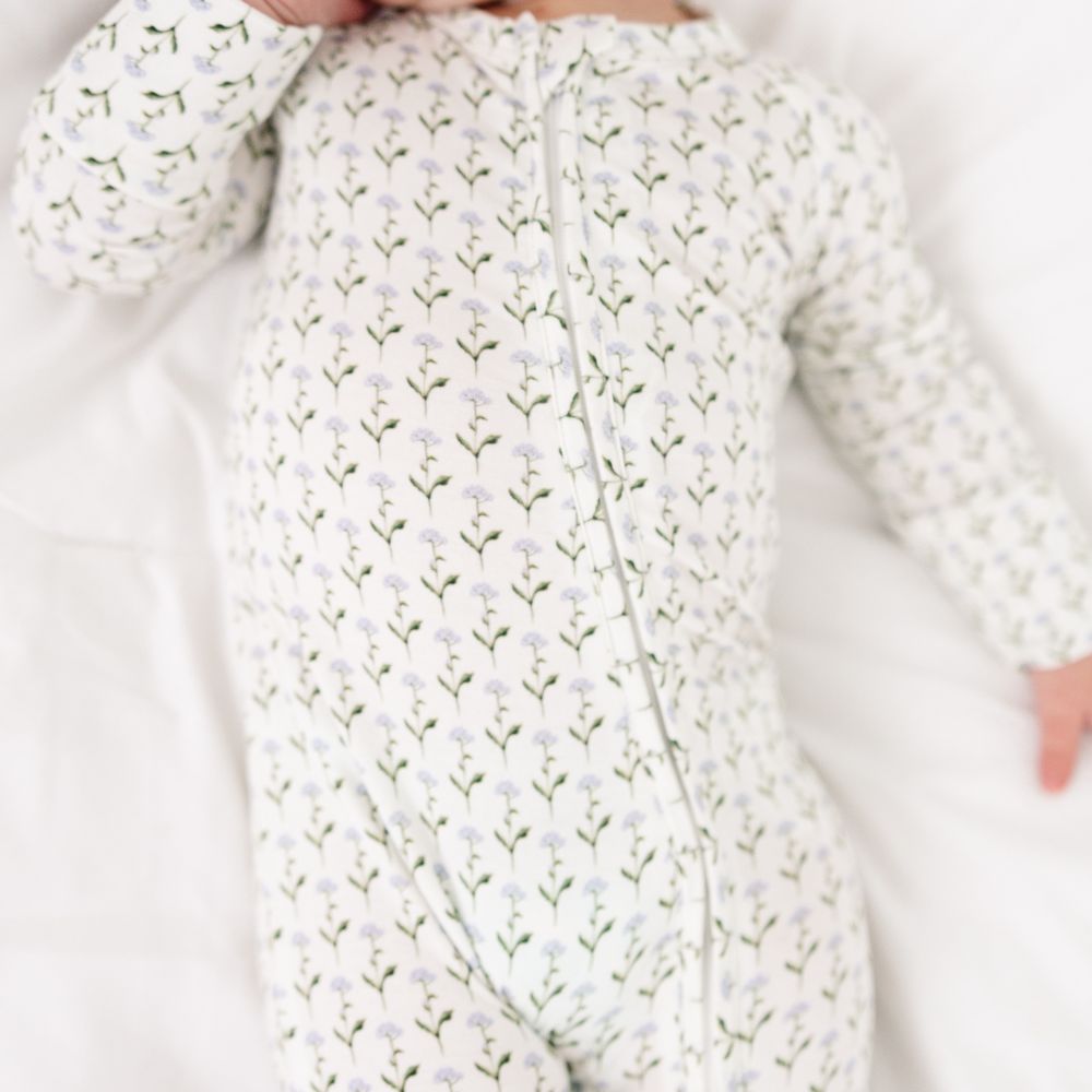 Close-up of Motette Lavender Lane Bamboo Sleeper showing floral detail on baby pajamas.