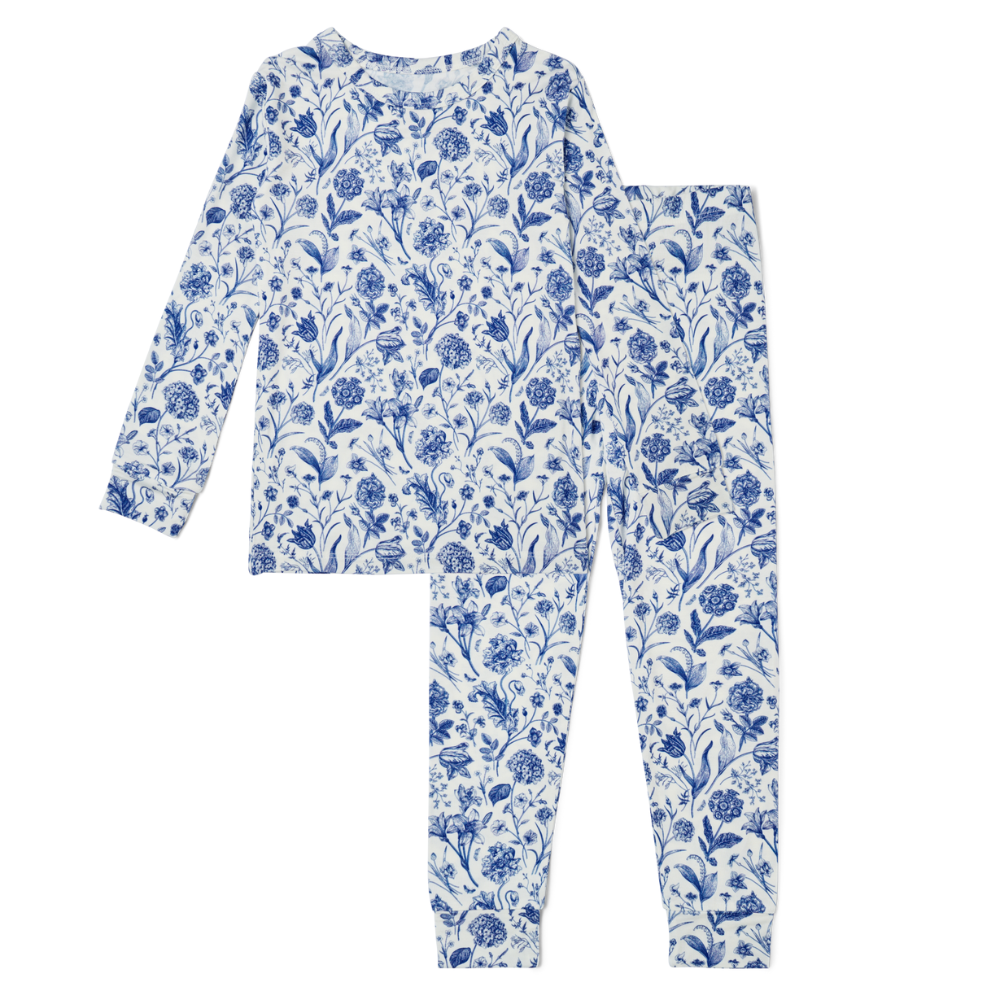 Flat lay of Motette Porcelain Vine blue and white floral two-piece bamboo toddler pajama set with long sleeve top and pants

