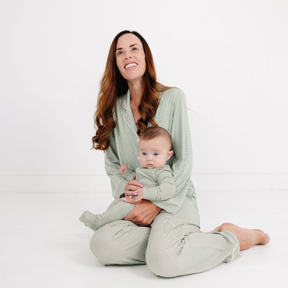 Mommy sitting on floor with baby in Motette Evergreen Stripe Bamboo Sleeper, cozy mommy and me set.