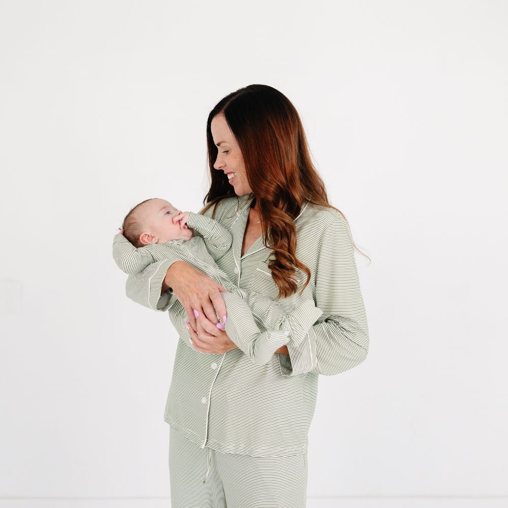 Mommy holding baby dressed in Motette Evergreen Stripe Bamboo Sleeper, mommy and me pajamas.