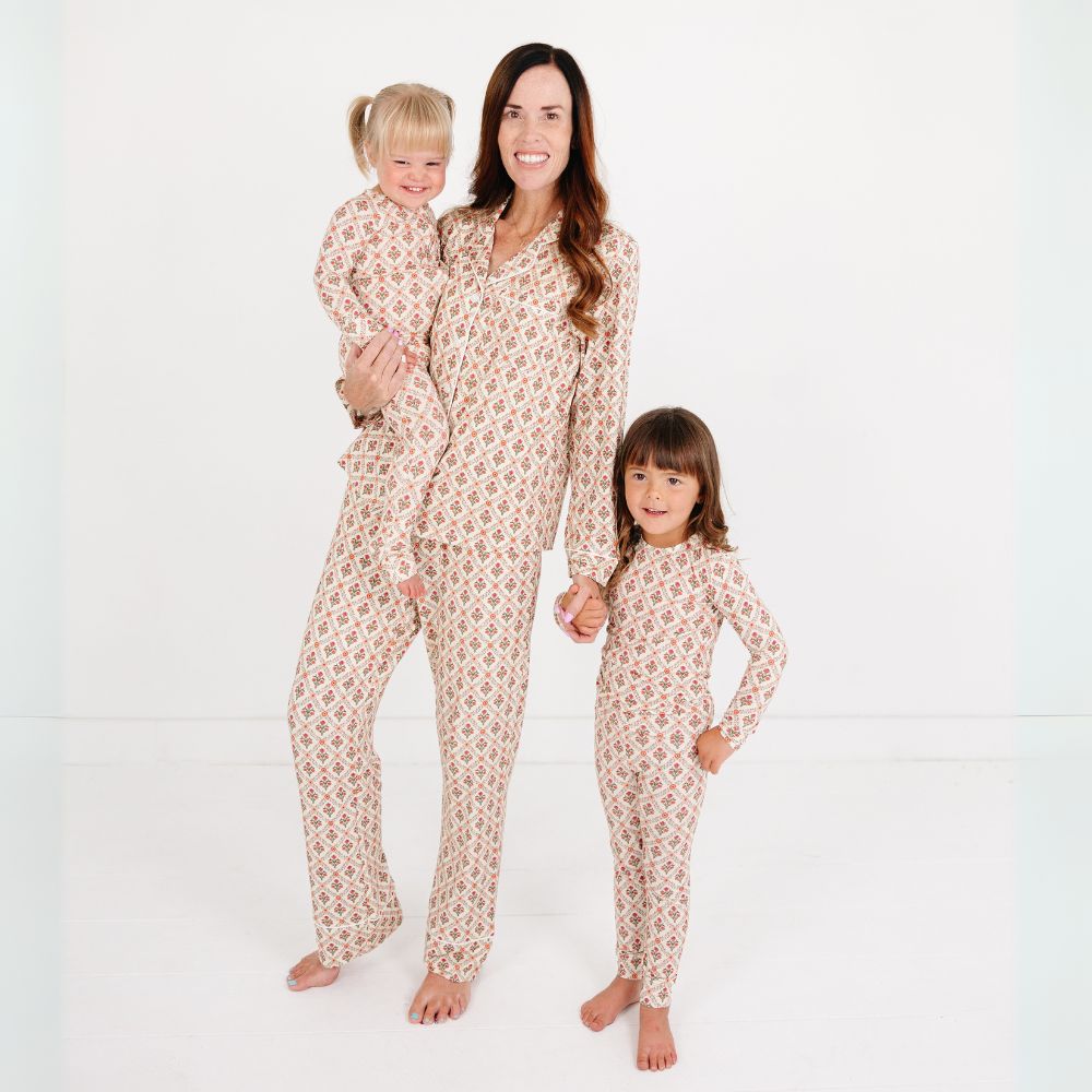 Mommy holding toddler and standing beside daughter, all wearing matching Motette Holly Trellis Bamboo Pajama Sets.