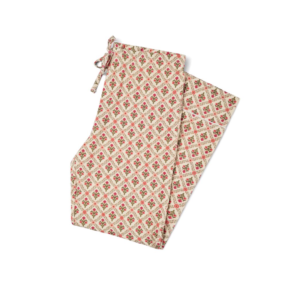 Motette Holly Trellis Bamboo Women's Pajama Pants laid flat, featuring a cream background with red and green floral trellis print and an adjustable drawstring waistband.