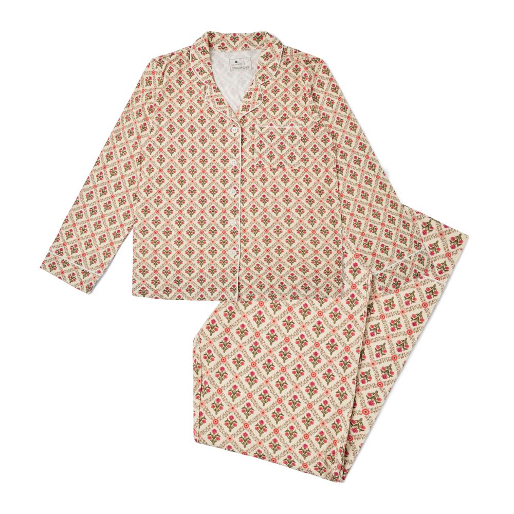 Motette Holly Trellis Long Sleeve and Pants Bamboo Women's Pajama Set laid flat, featuring a cream background with red and green floral trellis print, button-up top with pocket, and matching full-length pants.