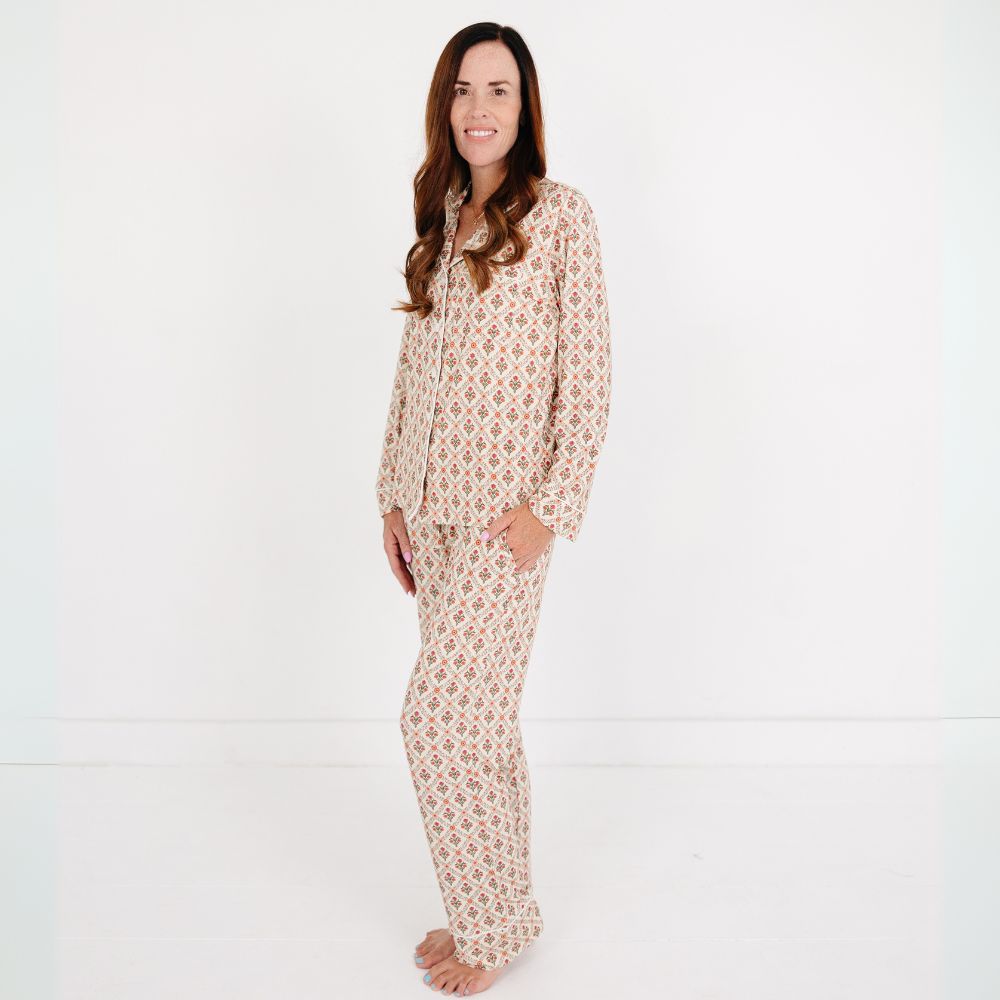 Mommy wearing the Motette Holly Trellis Bamboo Women's Pajama Set, featuring a cream background with red and green floral trellis print, button-up top, and matching full-length pants — part of the Mommy and Me and Siblings matching pajama collection.
