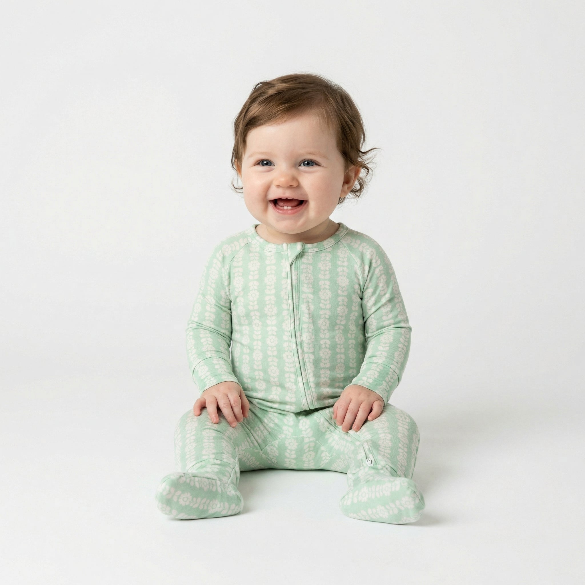 Top ranked breathable bamboo baby sleeper in green with white floral loved by parents of newborns with sensitive skin